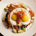 Chilaquiles rojos (triangle sliced and fried tortilla with red salsa)
