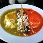 Huevos divorciados (Two eggs over fried tortilla with red and green salsa)